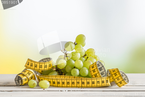 Image of Grapes with yellow measure tape