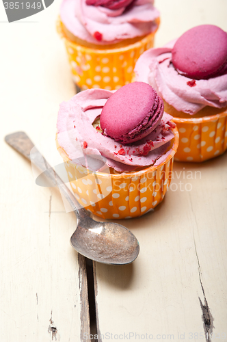 Image of pink berry cream cupcake with macaroon on top