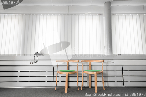 Image of Green chairs in a bright office