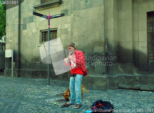 Image of editorial busker playing recorder Grand Canary Island Spain