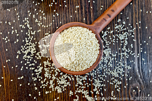 Image of Sesame seeds in ladle on board top