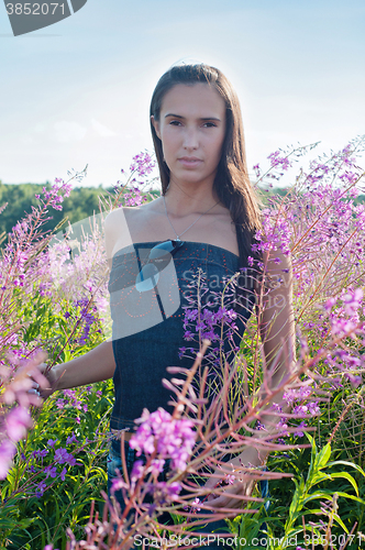 Image of Beautiful brunette woman in field