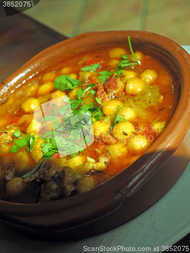 Image of homemade bowl  garbanzo bean soup with fresh basil as served in 