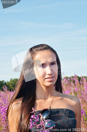 Image of Beautiful brunette woman in field