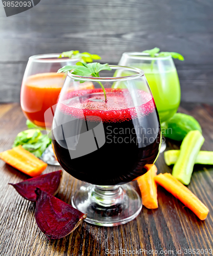 Image of Juice beet and cucumber in wineglass on board