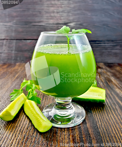 Image of Juice cucumber in wineglass on dark board