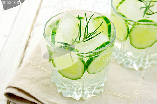 Image of Lemonade with cucumber and rosemary in two glassful on beige nap