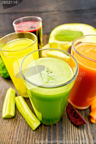 Image of Juice cucumber and vegetable in four glassful on board