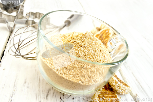 Image of Flour sesame in cup with cookies on board