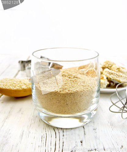 Image of Flour sesame in glassful on board