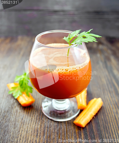Image of Juice carrot in wineglass on board
