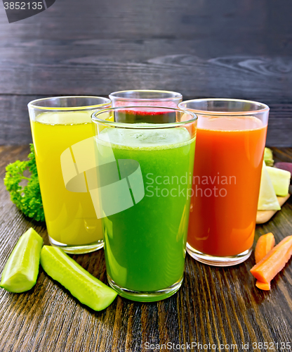 Image of Juice cucumber and vegetable in glassful on dark board