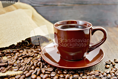 Image of Coffee in brown cup with bag on board