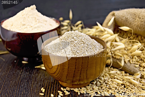 Image of Bran flakes in bowl with flour on board