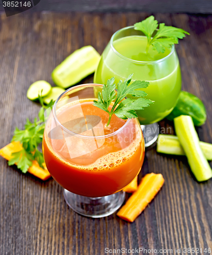 Image of Juice carrot and cucumber in two wineglass on board