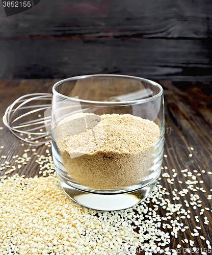 Image of Flour sesame in glassful on dark board