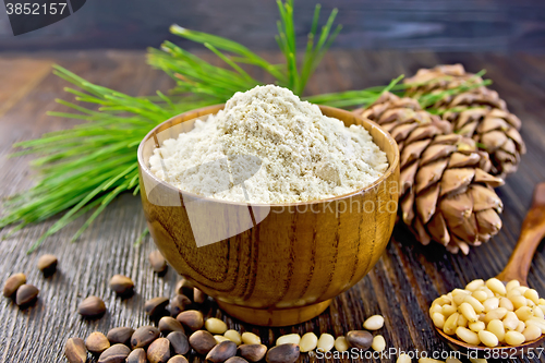 Image of Flour cedar in bowl with nuts on wooden board