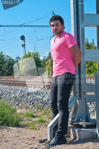 Image of Handsome young guy in pink t-shirt