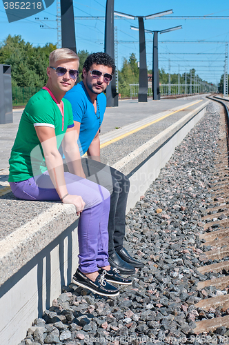 Image of Two young men sitting on the platform