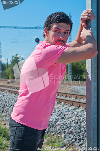 Image of Handsome young guy in pink t-shirt