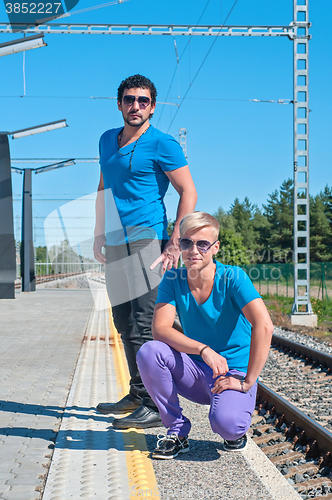 Image of Two young men standing on the platform