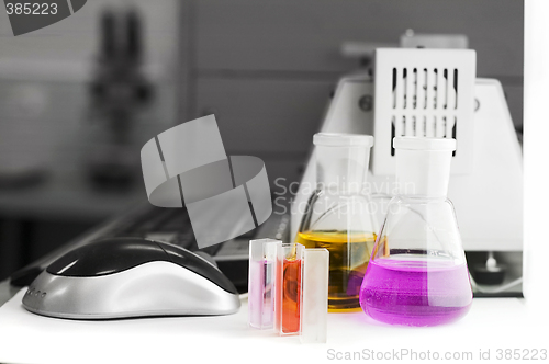 Image of laboratory flasks and computer keyboard