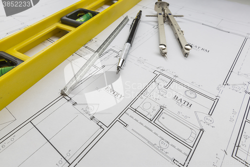 Image of Construction Level, Pencil, Ruler and Compass Resting on House P