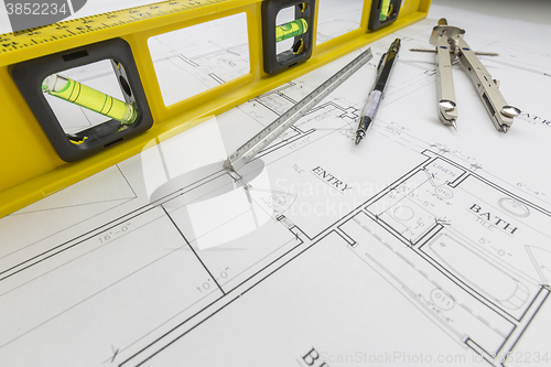 Image of Construction Level, Pencil, Ruler and Compass Resting on House P