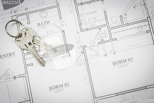 Image of Set Of New House Keys Resting On House Plans