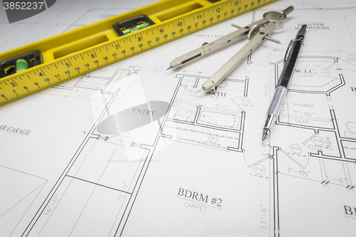 Image of Construction Level, Pencil, Ruler and Compass Resting on House P