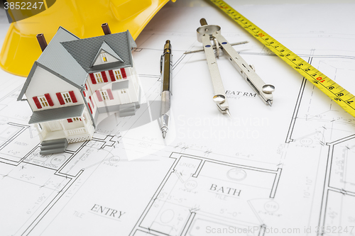 Image of Home, Measuring Tape, Hard Hat, Pencil, Compass on House Plans