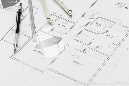 Image of Engineer Pencil, Ruler and Compass Resting on House Plans