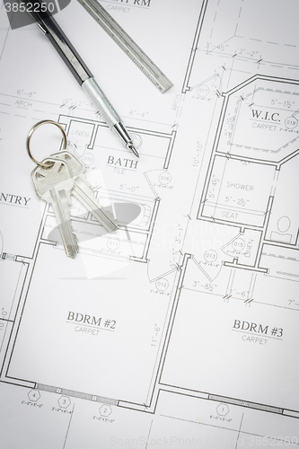 Image of Engineer Pencil, Ruler and Keys Resting On House Plans