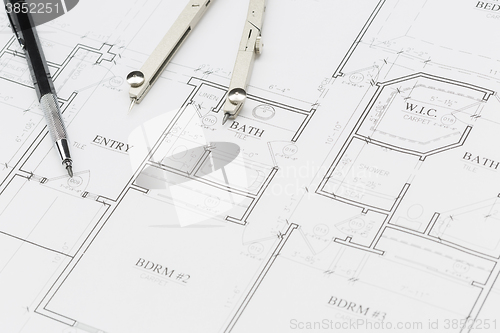 Image of Engineer Pencil and Compass Resting on House Plans