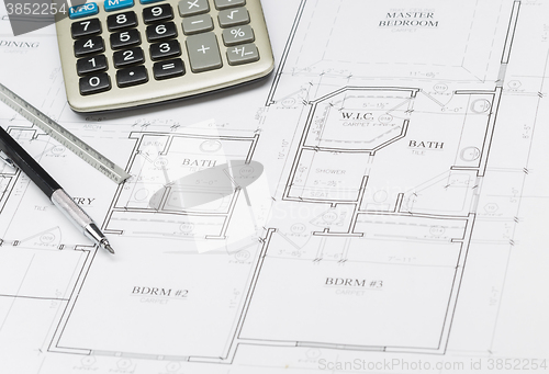 Image of Pencil, Ruler and Calculator Resting on House Plans