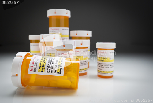 Image of Medicine Bottles on Reflective Surface and Grey Background