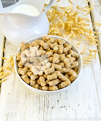 Image of Bran in bowl with milk on board