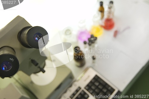 Image of laboratory work place with microscope and test tubes