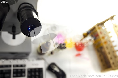 Image of laboratory work place with microscope and test tubes