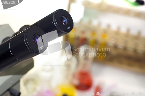 Image of laboratory work place with microscope and test tubes