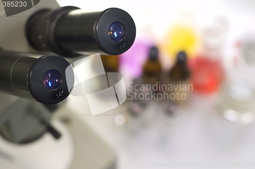 Image of laboratory work place with microscope and test tubes