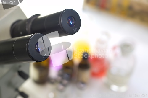 Image of laboratory work place with microscope and test tubes