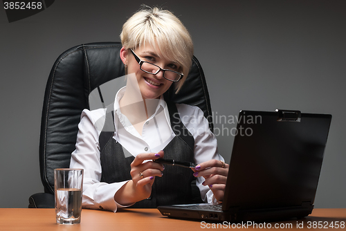 Image of Attractive businesswoman with laptop