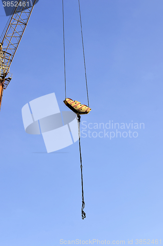 Image of Crane and building construction site against blue sky