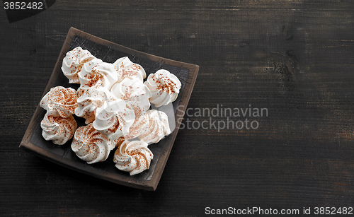 Image of meringue cookies on dark wooden table