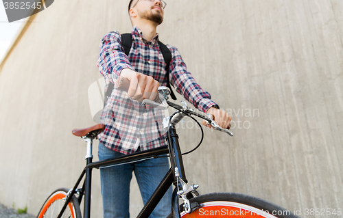 Image of hipster man with fixed gear bike and backpack