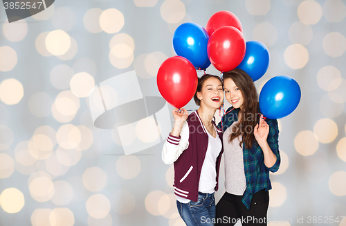 Image of happy teenage girls with helium balloons