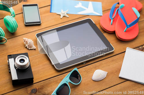 Image of close up of tablet pc and travel stuff