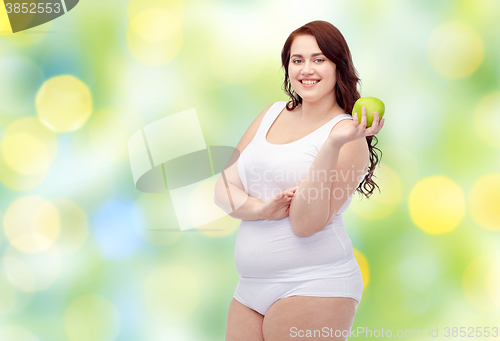 Image of happy plus size woman in underwear with apple