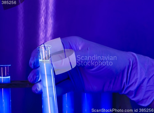 Image of hand in glove with test tubes